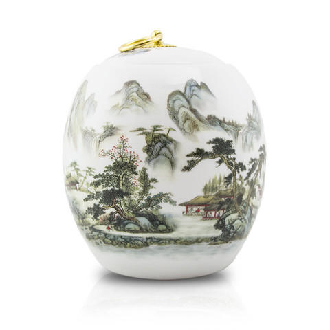 Elegant ceramic cremation urn with a mountain scene and copper plated ring handle.