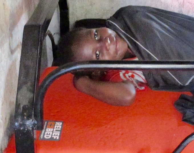 Happy child on their new Relief Bed, snuggled in their SHEEX.