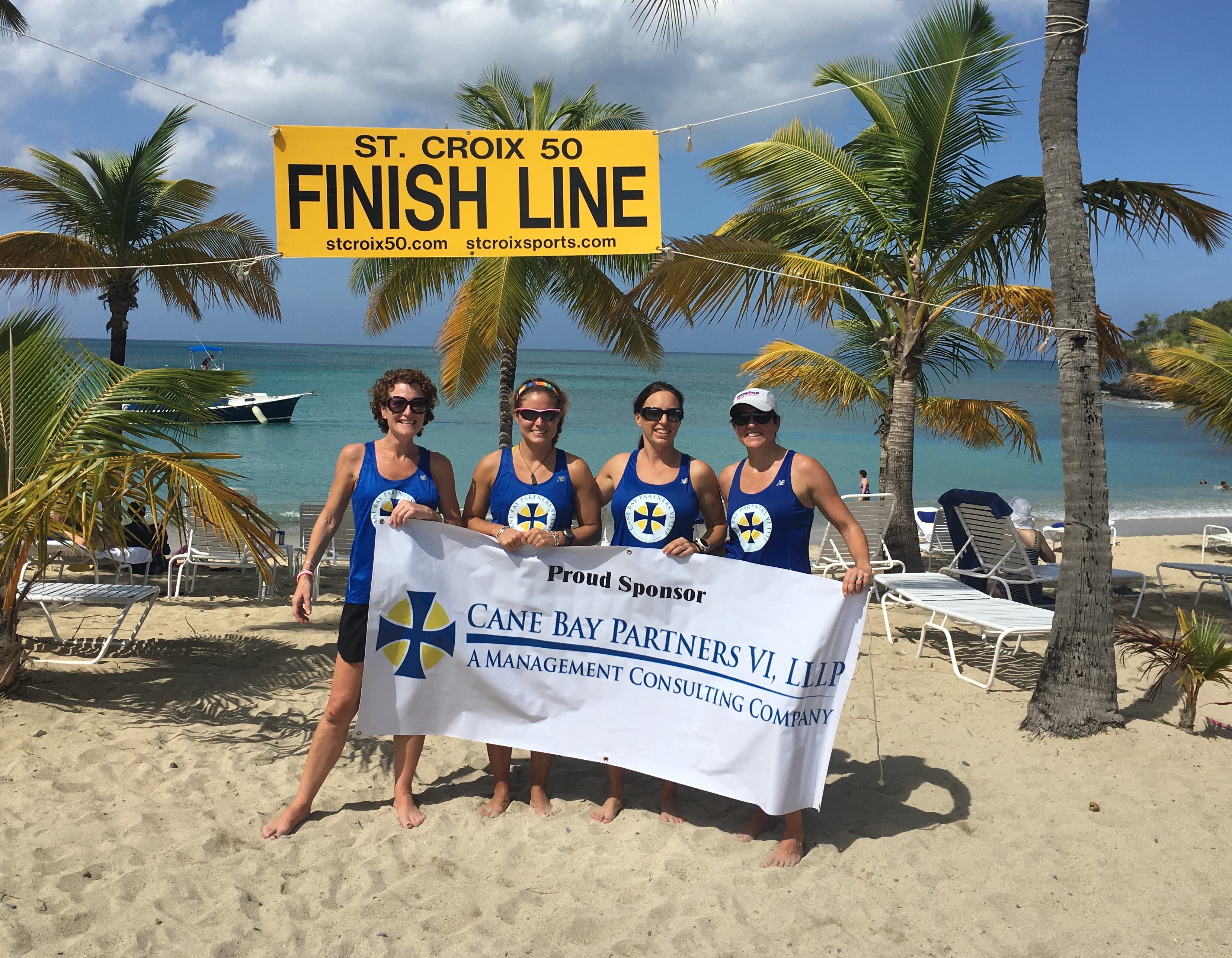 Team members sponsored by Cane Bay Partners VI, LLLP  include St. Croix residents (left to right) Colleen Chin, Robin Seila, Esther Ellis and Julie Sommer pose by the finish line on Mermaid Beach at T