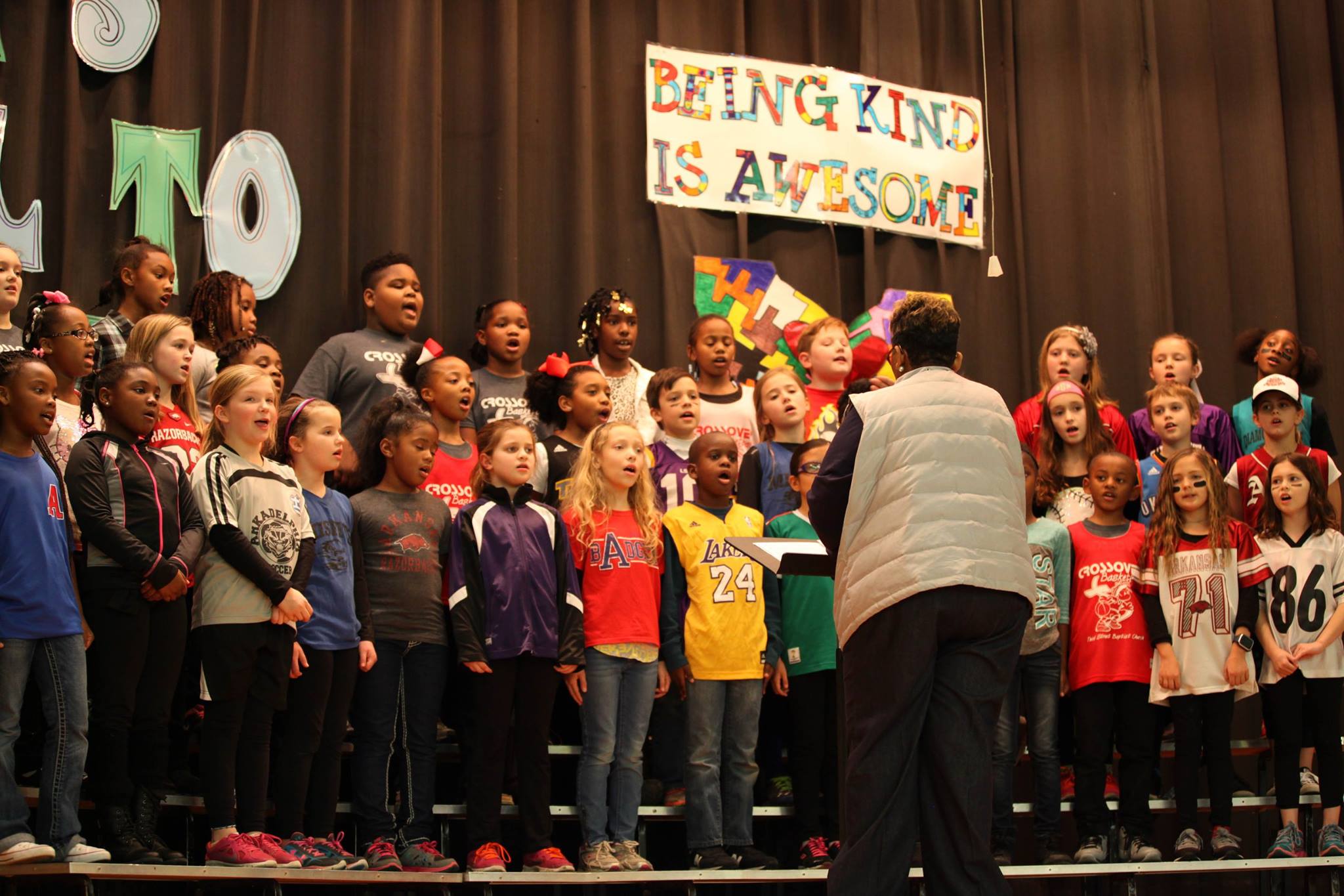 Students sing a happy kindness song at school-wide assemblies.