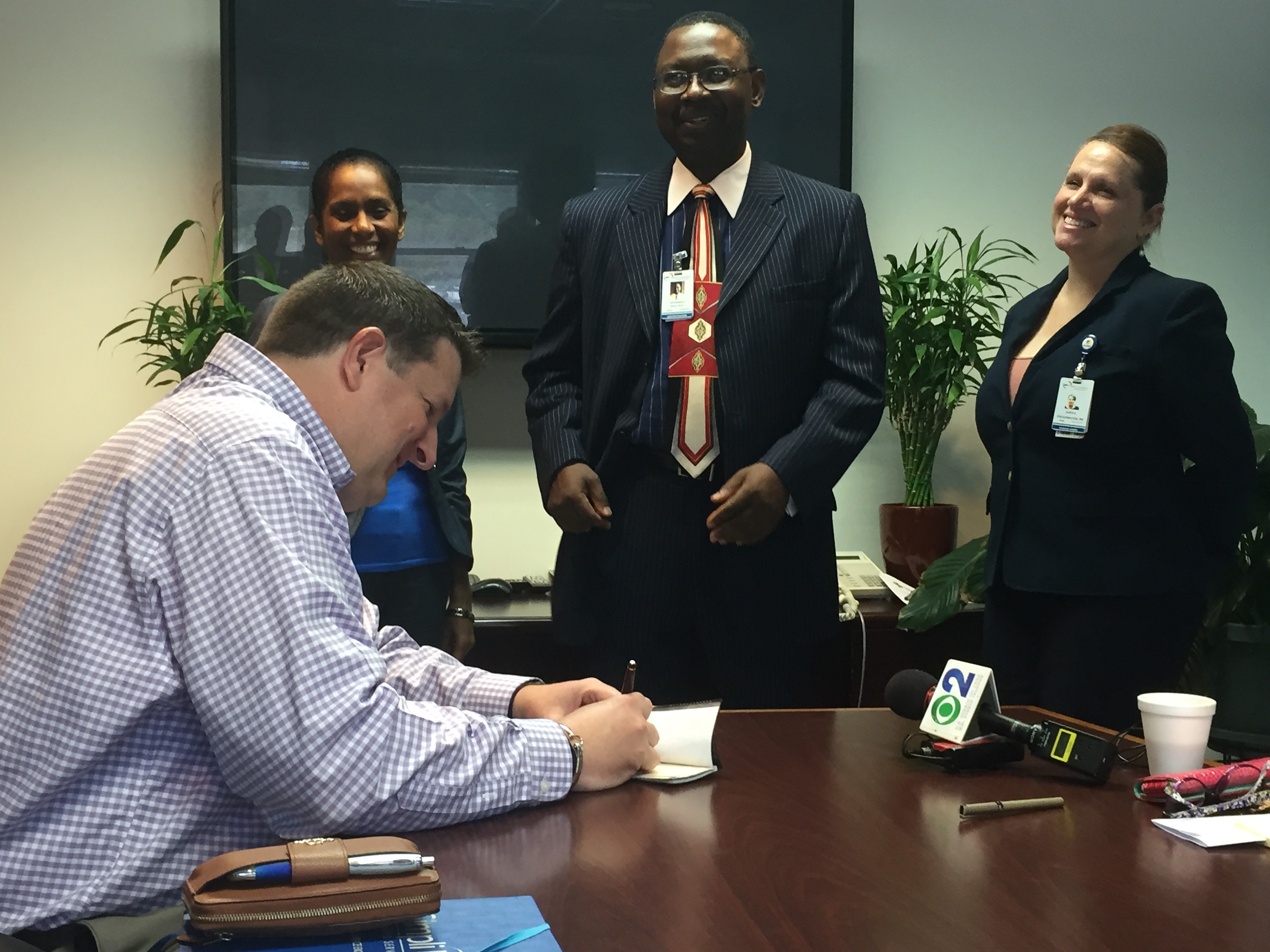 David A. Johnson, co-founder of St. Croix-based consulting firm Cane Bay Partners VI, signs a $25,000 donation to the Gov. Juan F. Luis Hospital on Wednesday, completing a $50,000 donation to the Wome