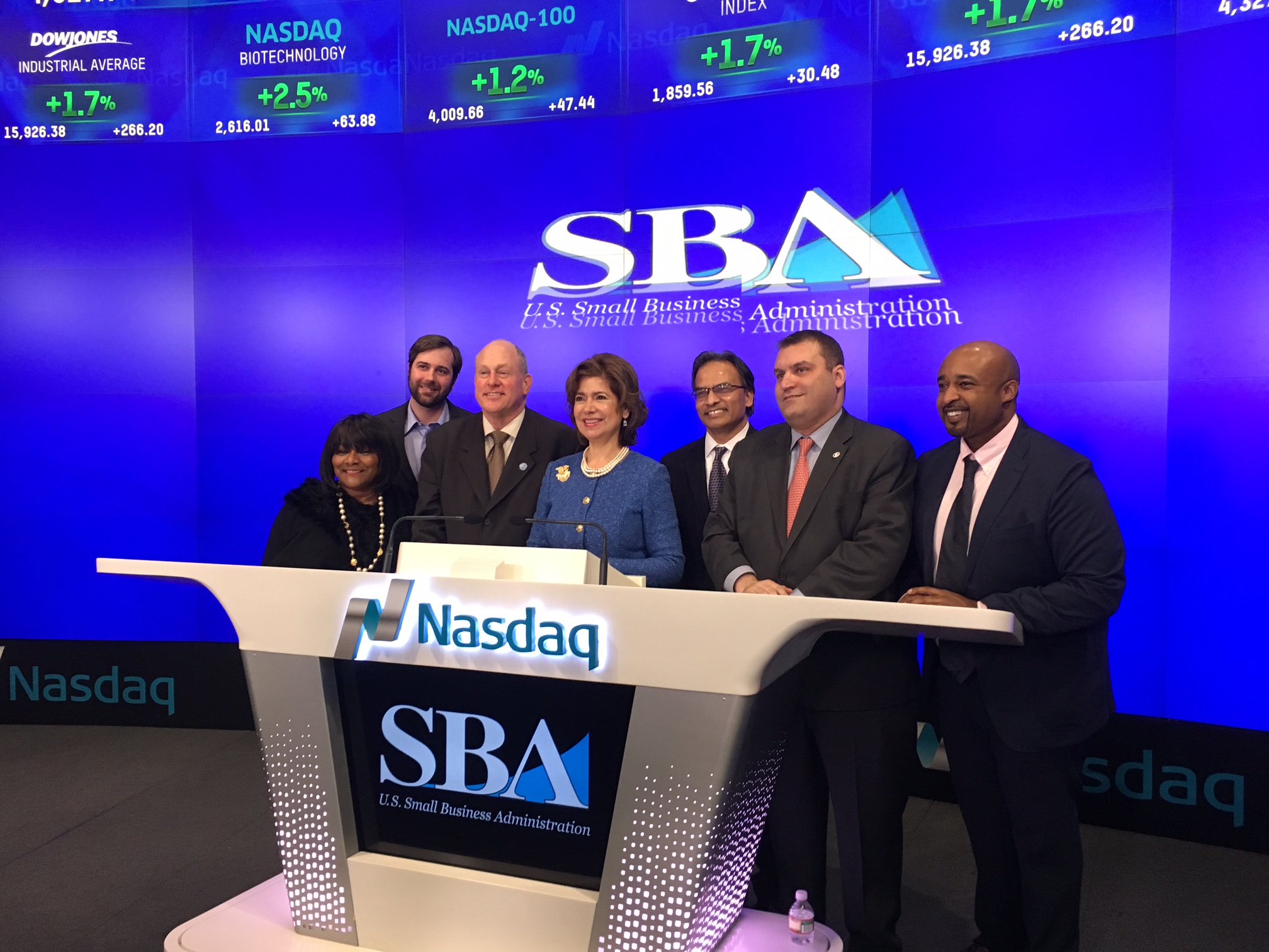 SBA Emerging Business Leader Aziz Ahmad, CEO of UTC Associates, joins Maria Contreras-Sweet, Administrator of SBA and a member of President Obama's cabinet, in NASDAQ closing Bell ceremony.