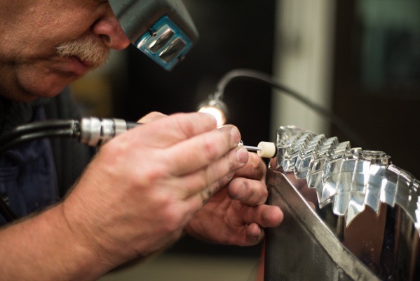 Precise craftsman Steve Heitman polishes an automotive lighting mold.