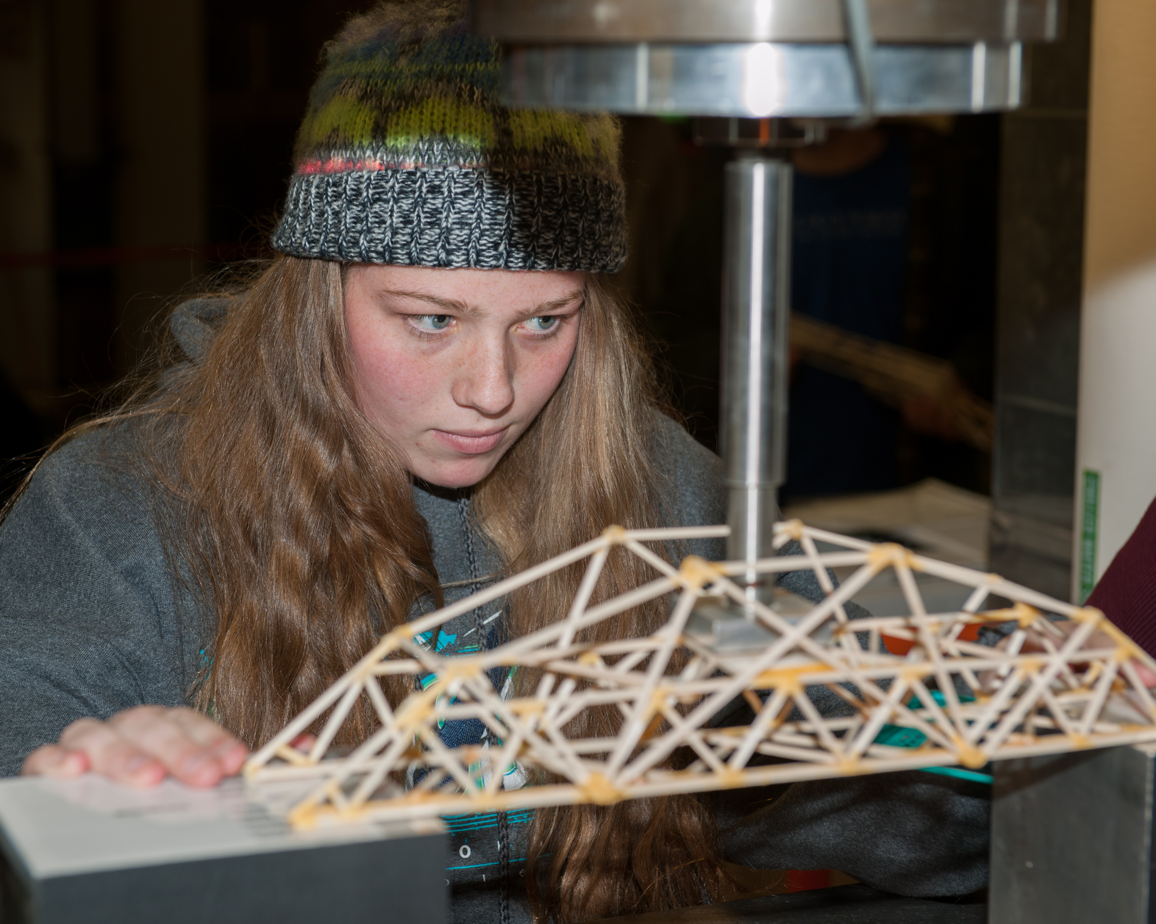 A student setting their bridge to be tested at the Colorado High School Bridge Building Contest.