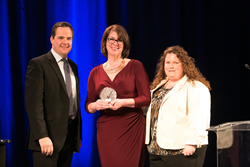 Simon Relph presents the Stevie Award to Paycor employees Catherine Dunwoodie (L) senior director, Client Support, and Kelly Sipple, configuration specialist for New Accounts