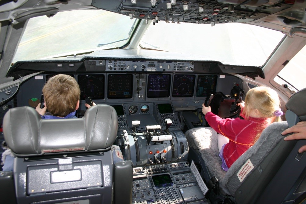 Children can get hands on controls during the static display of aircraft at the Great Alaska Aviation Gathering.