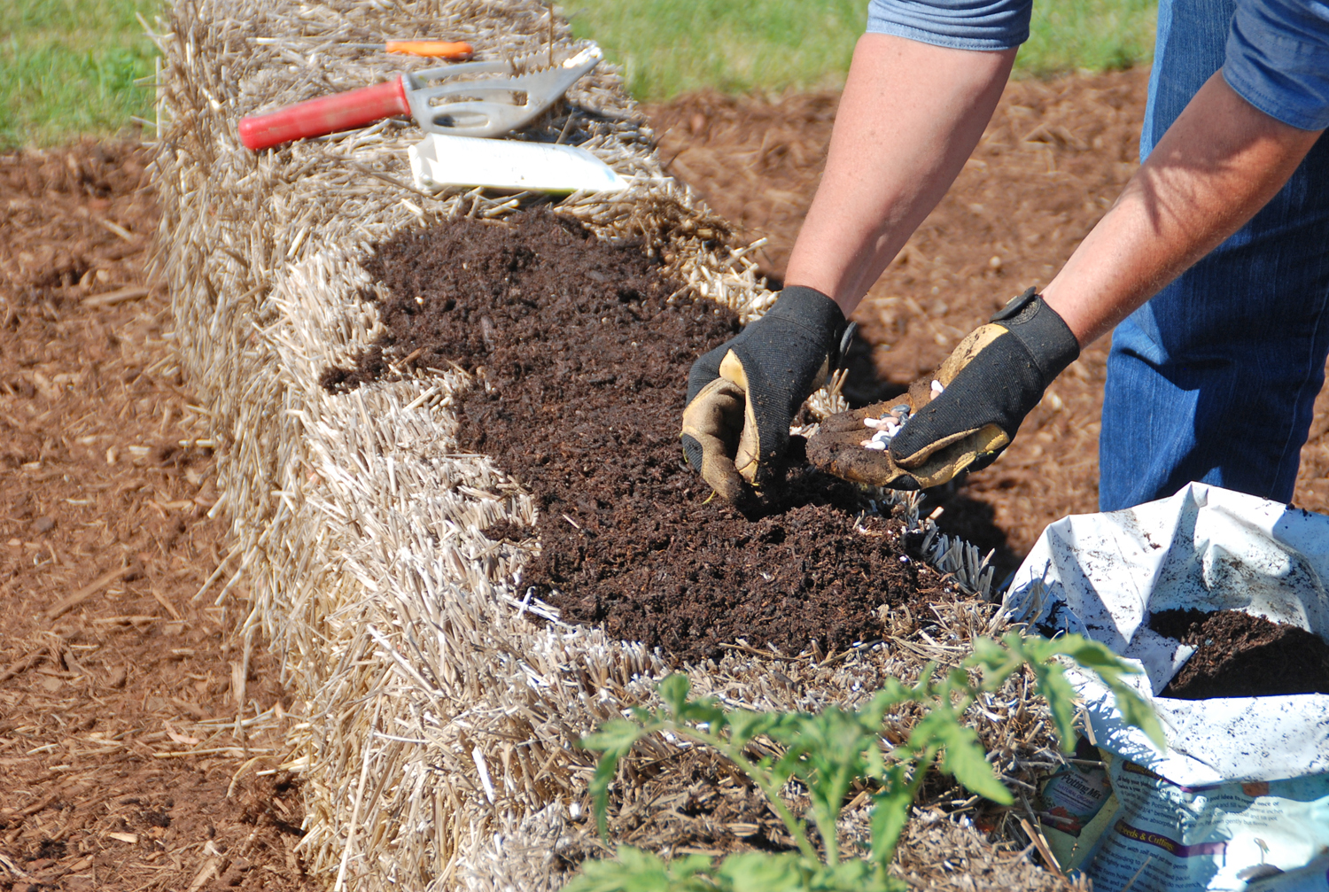 Create a planting bed for seeds by covering the straw bale with a one- to two-inch layer of planting mix.