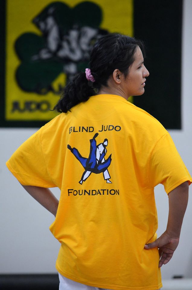 Christella Garcia wearing the T-Shirt of the Blind Judo Foundation