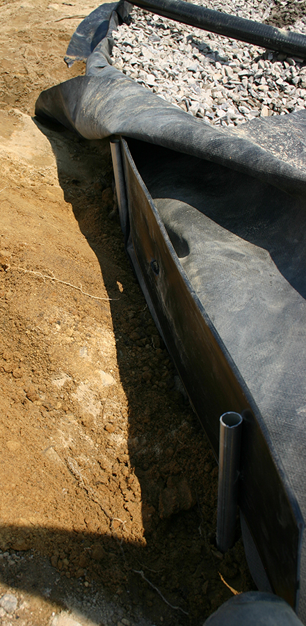 Six-inch high Super-Edg landscape edging supports the outside edge of ponds, garden swim ponds and water gardens