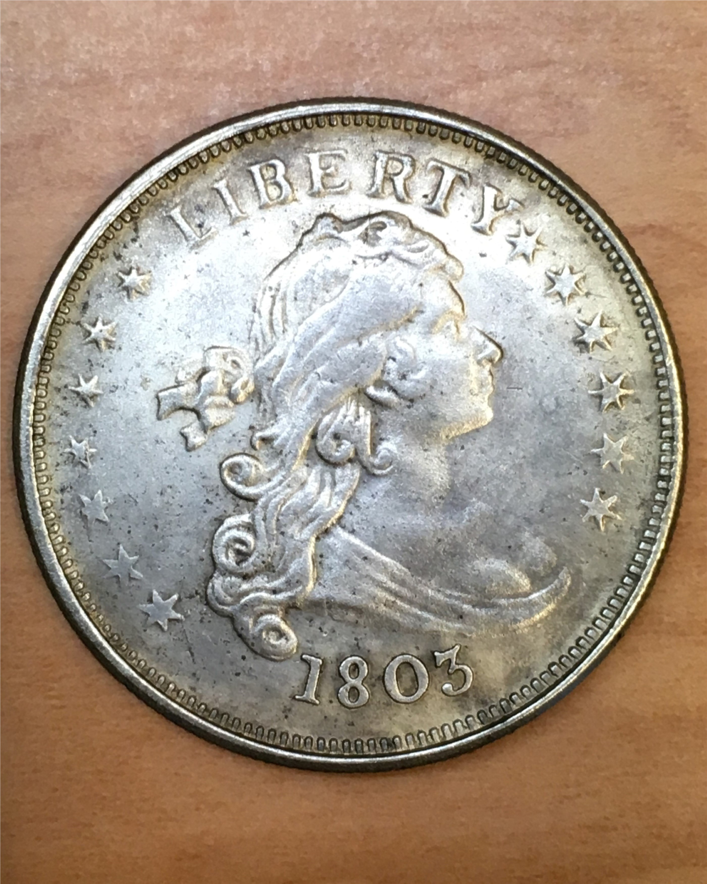 Genuine 1803 Draped Bust design U.S. silver dollars in Very Fine condition are valued at about $3,000. This fake was offered in a Hong Kong flea market for less than $3. (Photo by Donn Pearlman.)