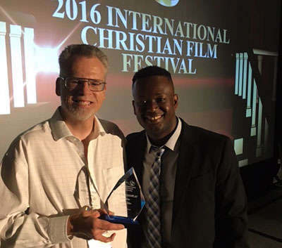 Stephan Schultze, executive director of Liberty University's Cinematic Arts, Zaki Gordon Center and writer/director of "God's Compass," (left) receives the 2016 International Christian Film Festival B