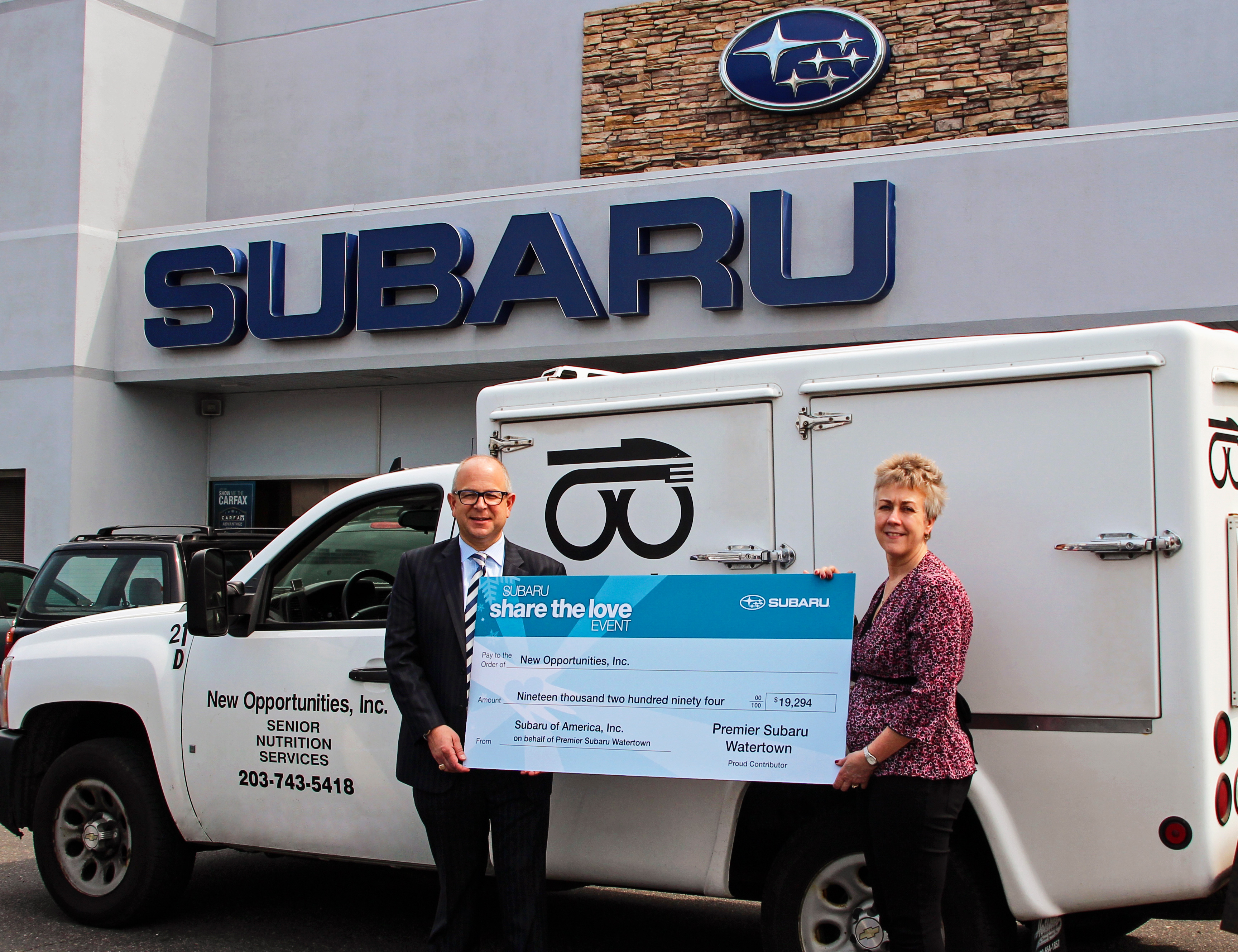 Robert J Alvine, President, Premier Subaru Watertown presents Lisa LaBonte, Program Director, New Opportunites with a check for more than $19,000.