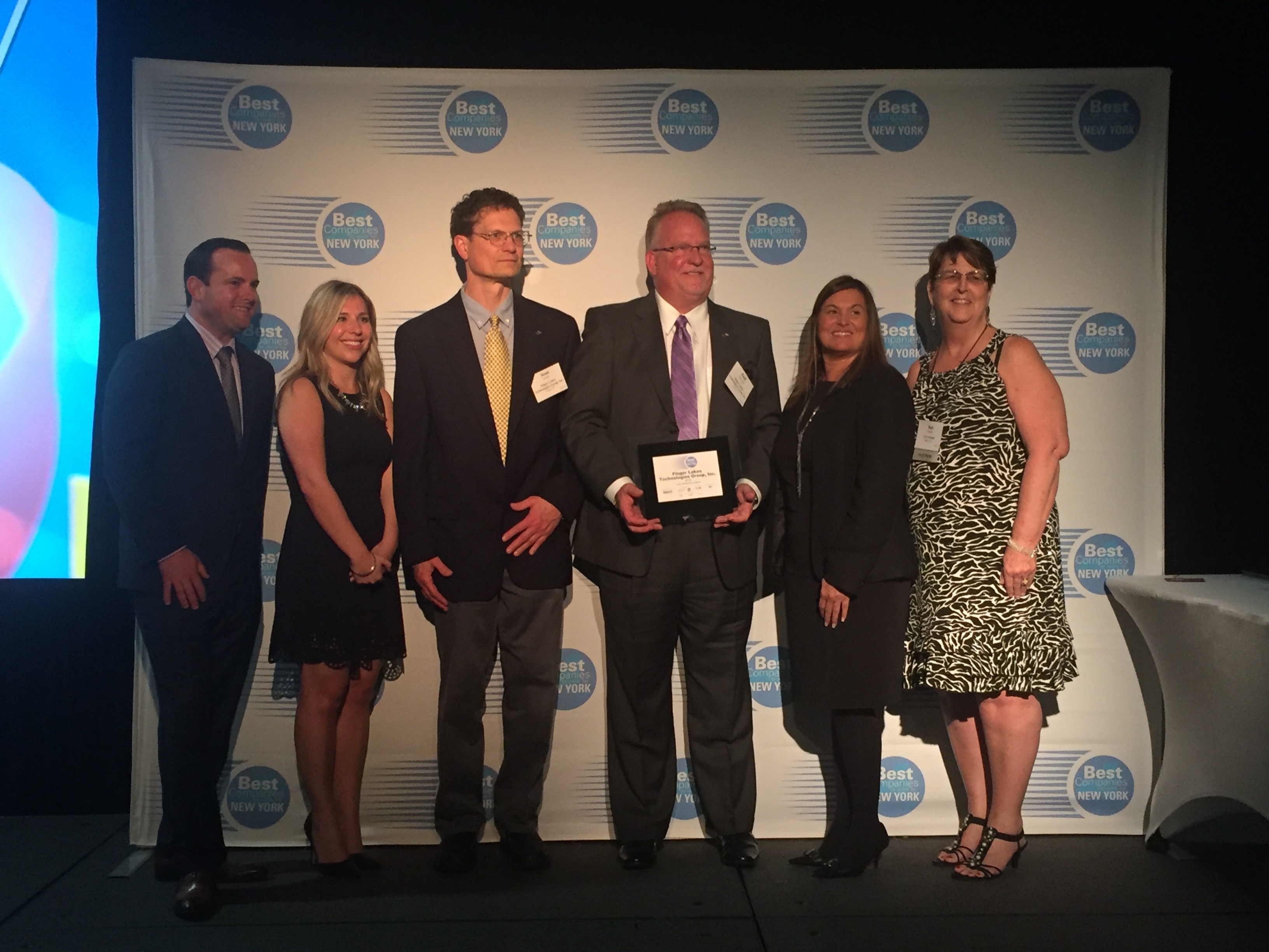 Paul H. Griswold, President and CEO accepting the #18 ranking for Best Place to work in NYS Award on behalf of Finger Lakes Technologies Group, Inc.