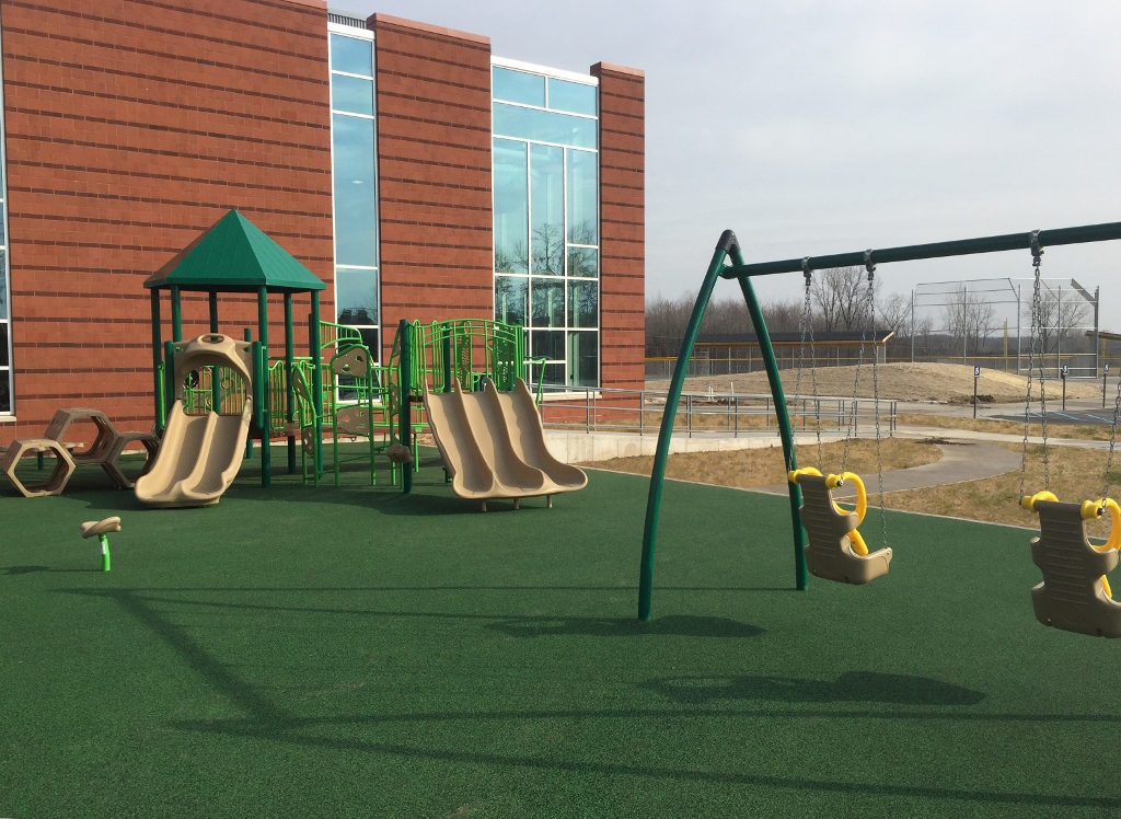 The ADA accessible playground includes climbers, slides and adaptive swing seats.