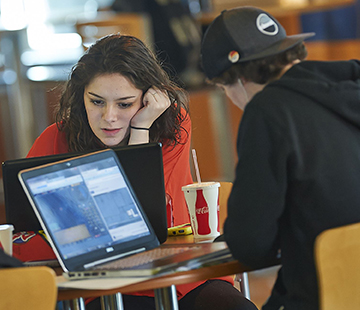 Students studying at Husson University's G. Pierce Webber Campus Center in Peabody Hall.