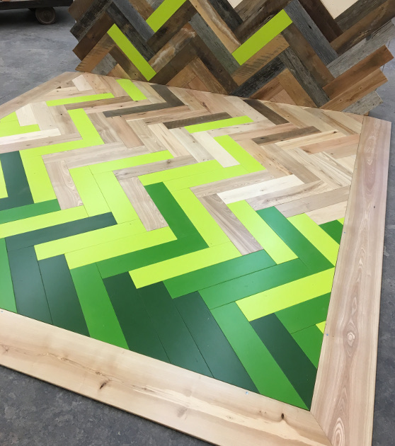 Shades of green and natural patinated wood surfaces come together in a shattered herringbone pattern that ICFF attendees can see and feel May 14 – 17 in Pioneer Millworks booth #2520.