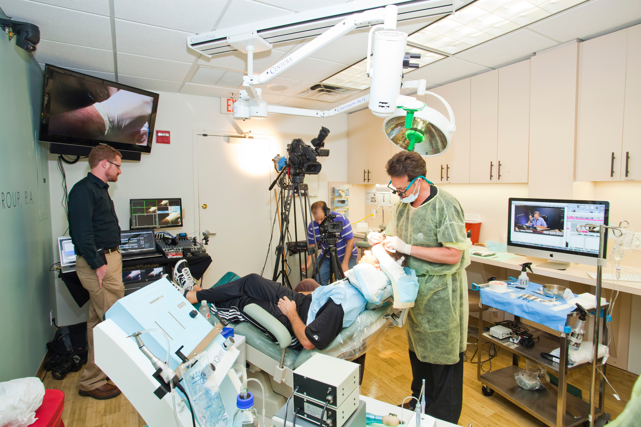 Dr. Bauman performing live hair transplant procedure.