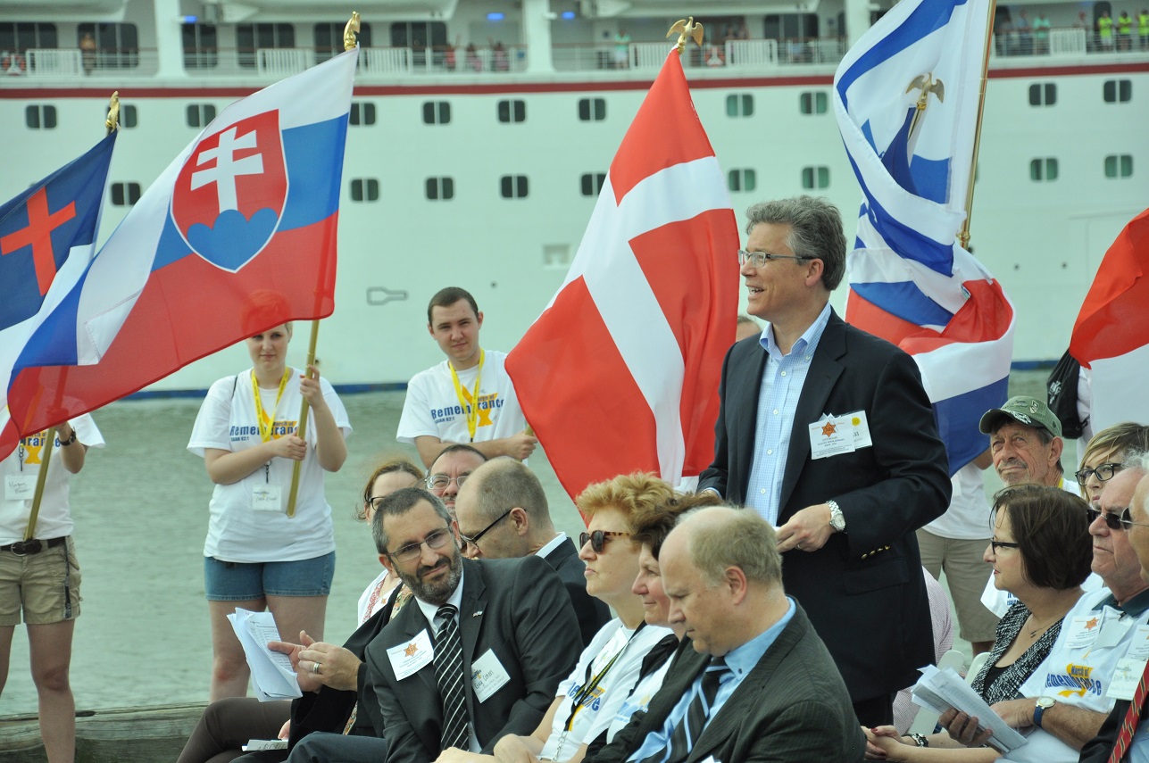 Students hold flags representing the respective countries of diplomats who secretly helped save Jews