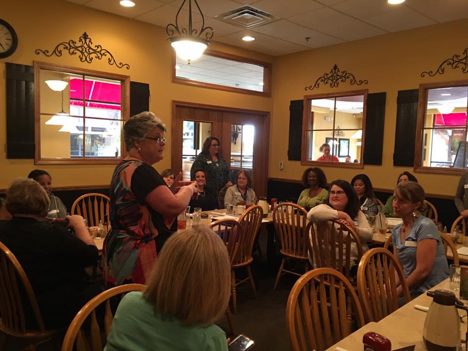 NAPW Member, Susan Campbell, sharing details on her Armaband with her fellow Carrollton, TX Chapter members