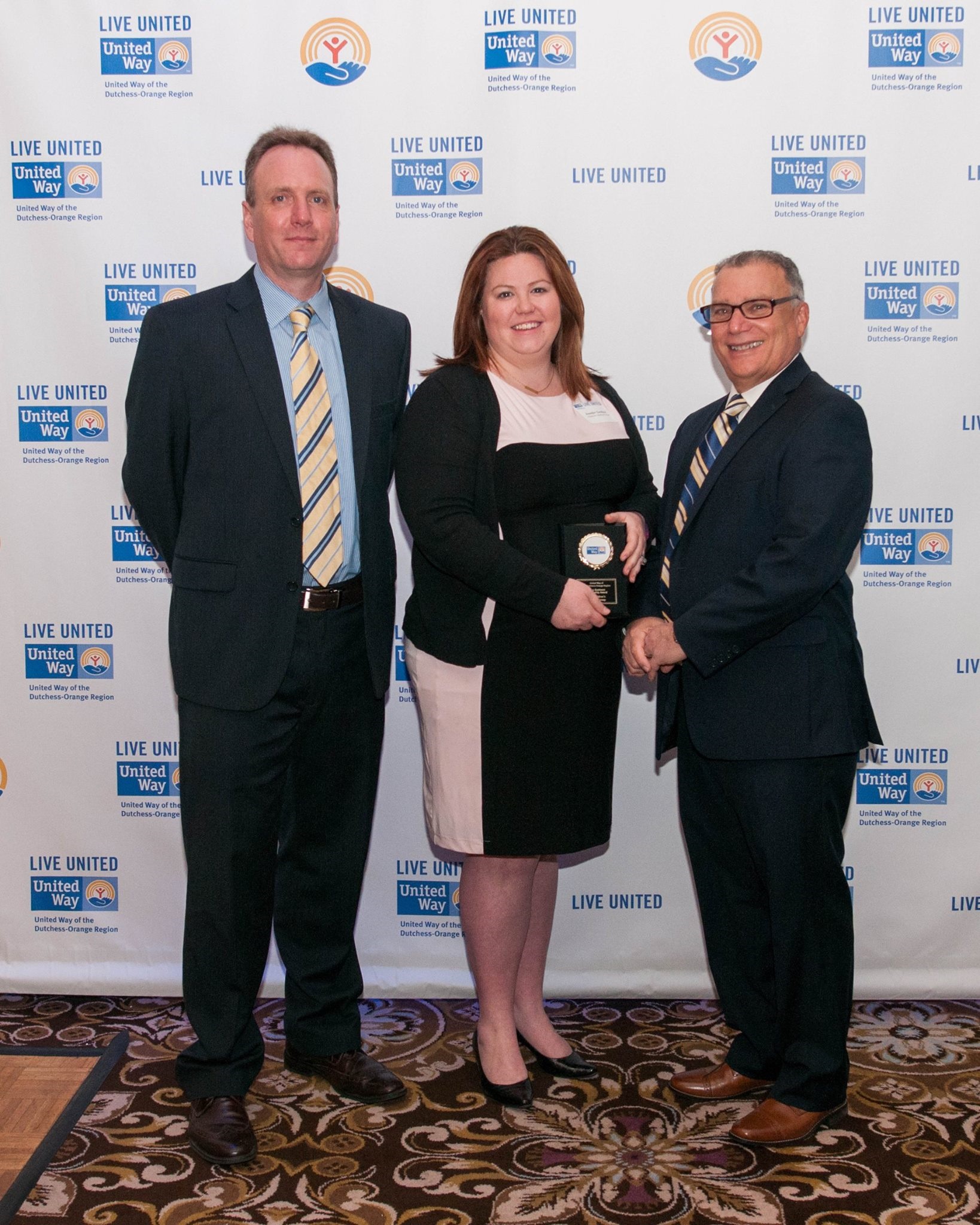 Jennifer Gardiner receives The Children's Medical Group's Business Leadership Award from UWDOR board vice chair Dave Jolly and board chair Barry Rothfeld at Celebration of Service: A Community United