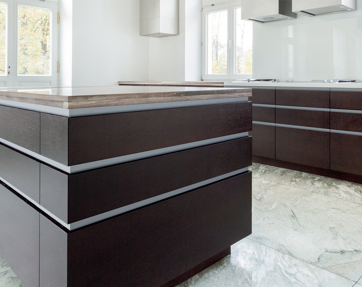Schwinn Handle-Free Cabinet Hardware installed in a modern kitchen.