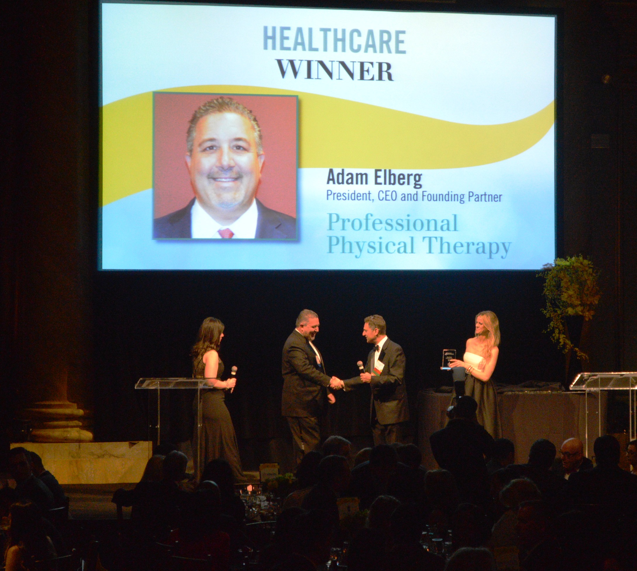 Adam Elberg accepting Deals of Distinction Award for Healthcare Industry