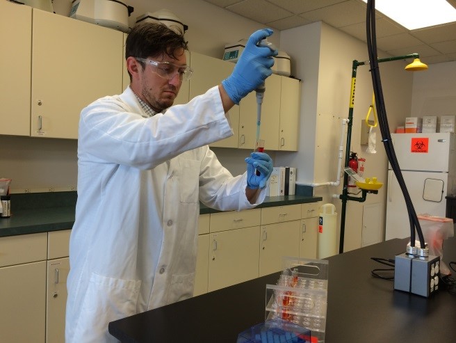 Dr. Kyle Riding working in Keiser University lab at Orlando campus