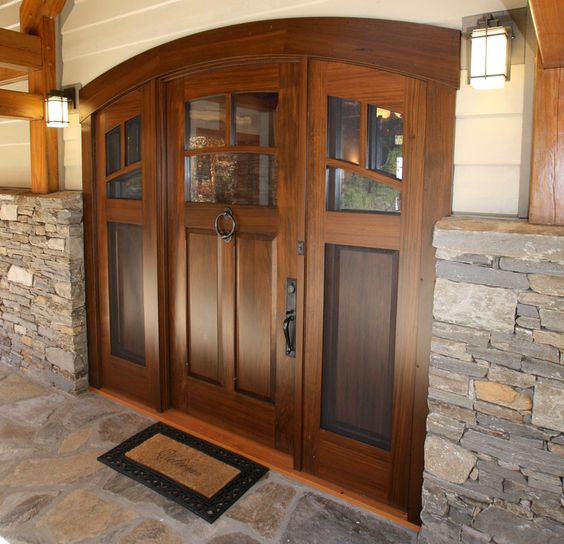 The entry to this LEED-H Gold home is a NEWwoodworks custom-crafted curved walnut door, double the usual thickness to better fit two screened and glass filled sidelights.