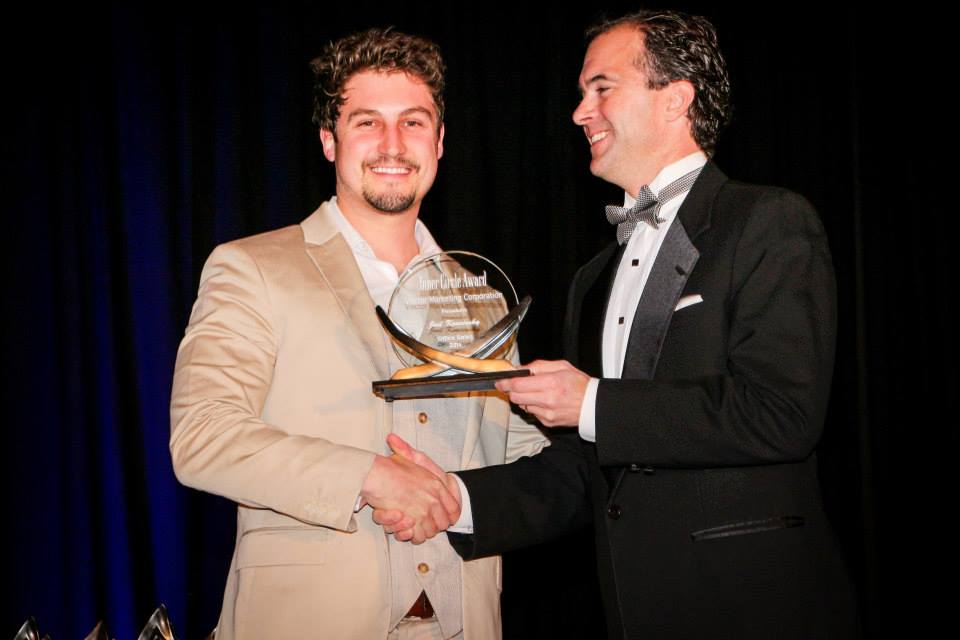 Vector Marketing’s Joel Koncinsky (left) receives the Inner Circle Award from regional manager Loyd Reagan at a company year-end banquet. Vector has named Koncinsky its public relations manager.