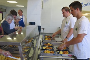 Volunteers from Citrin Cooperman help serve lunch to nearly 400 guests in Eva’s Village Community Kitchen.
