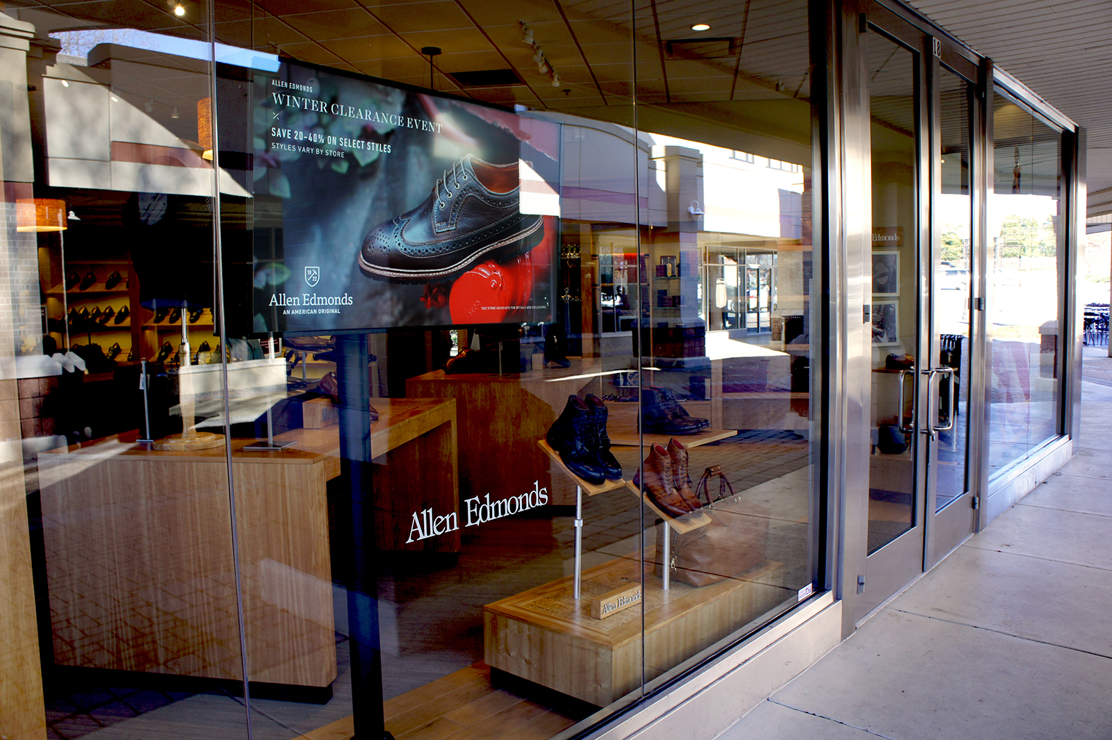 Storefront digital signage attracts and engages new customers for premium men's retailer Allen Edmonds.