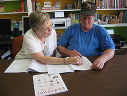 A tutor from Rockingham County Literacy Project in Eden, N.C., a past National Book Fund recipient, uses an educational book to teach an adult learner to read.