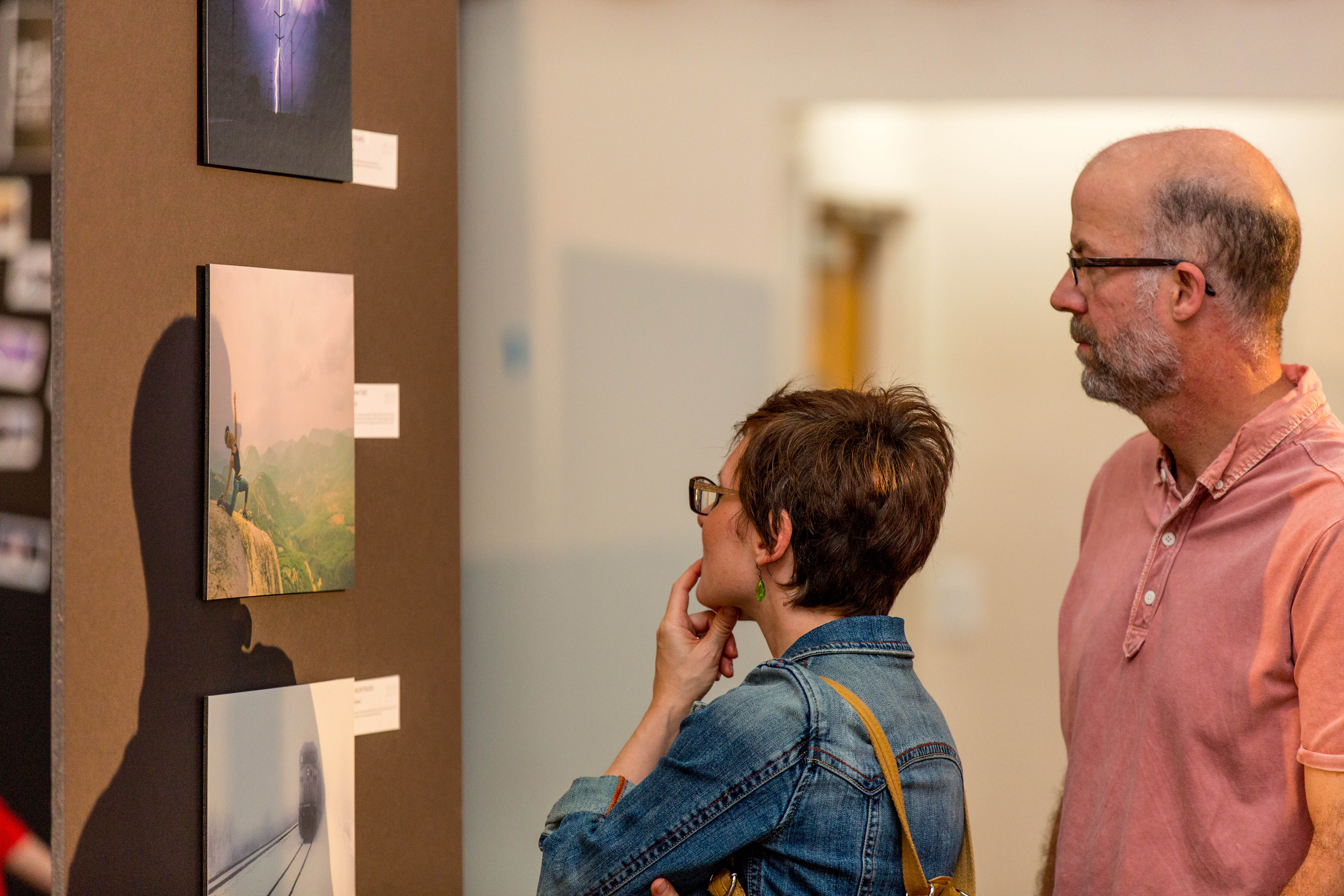 Attendees Explore a Photography Exhibit at Thin Line 2016