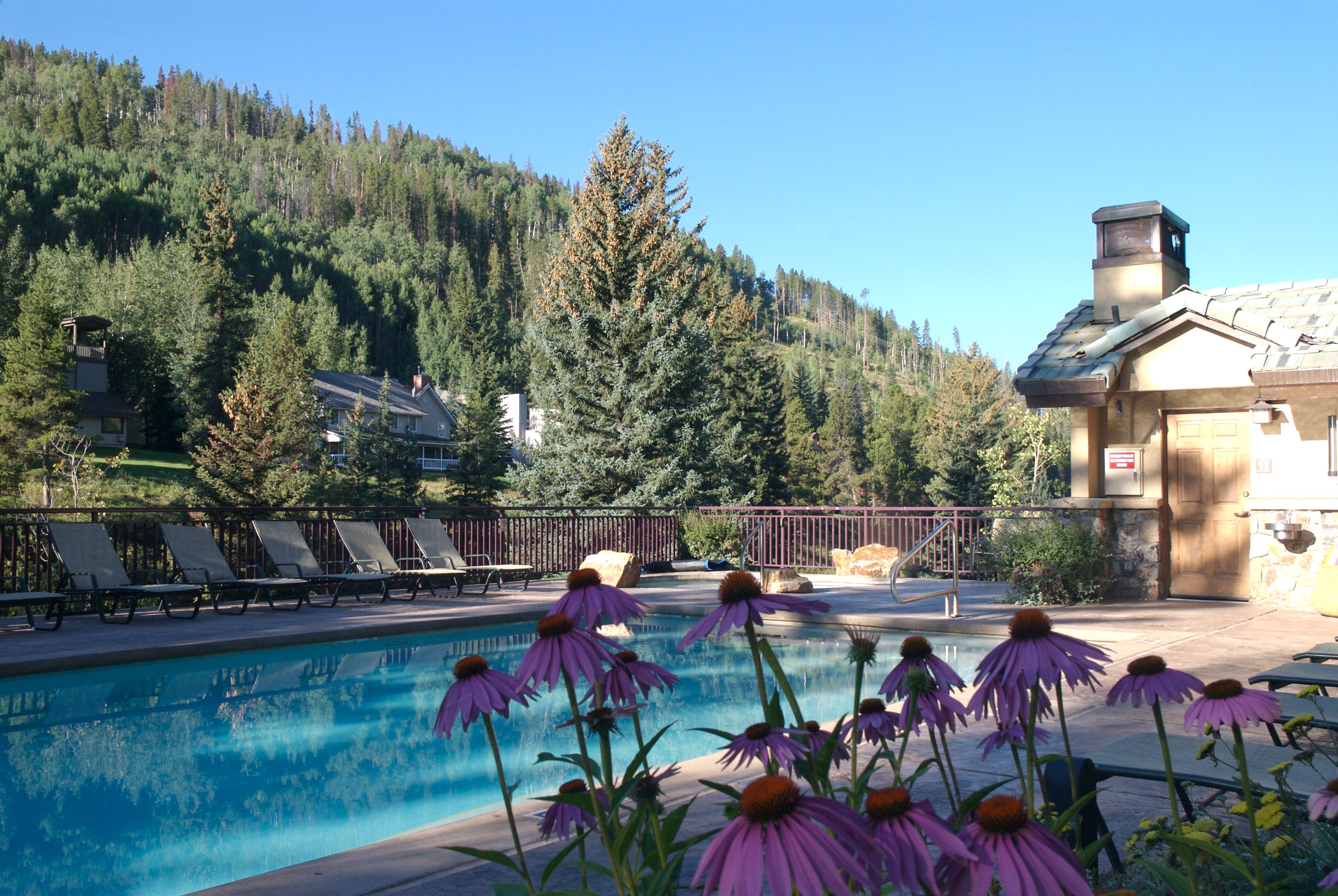Antlers at Vail hotel’s “pool with a view” overlooks Vail Mountain and rushing Gore Creek with two hot tubs for relaxing muscles tired from the day’s activities.