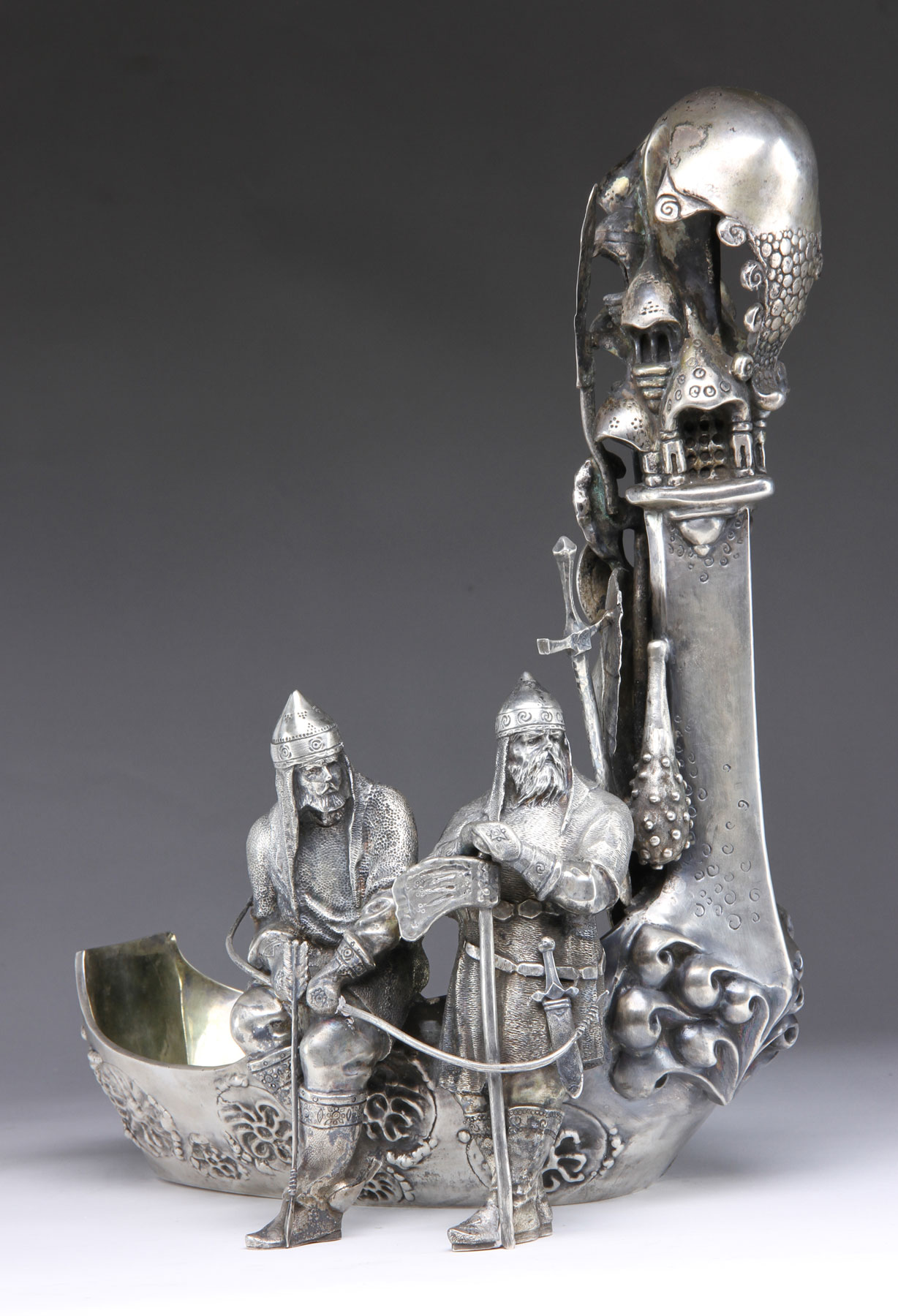 19th century Russian solid silver kovsh, showing two Vikings with armor, marked "84" in Cyrillic for .875 silver, signed on base "P. Ovchinkova"