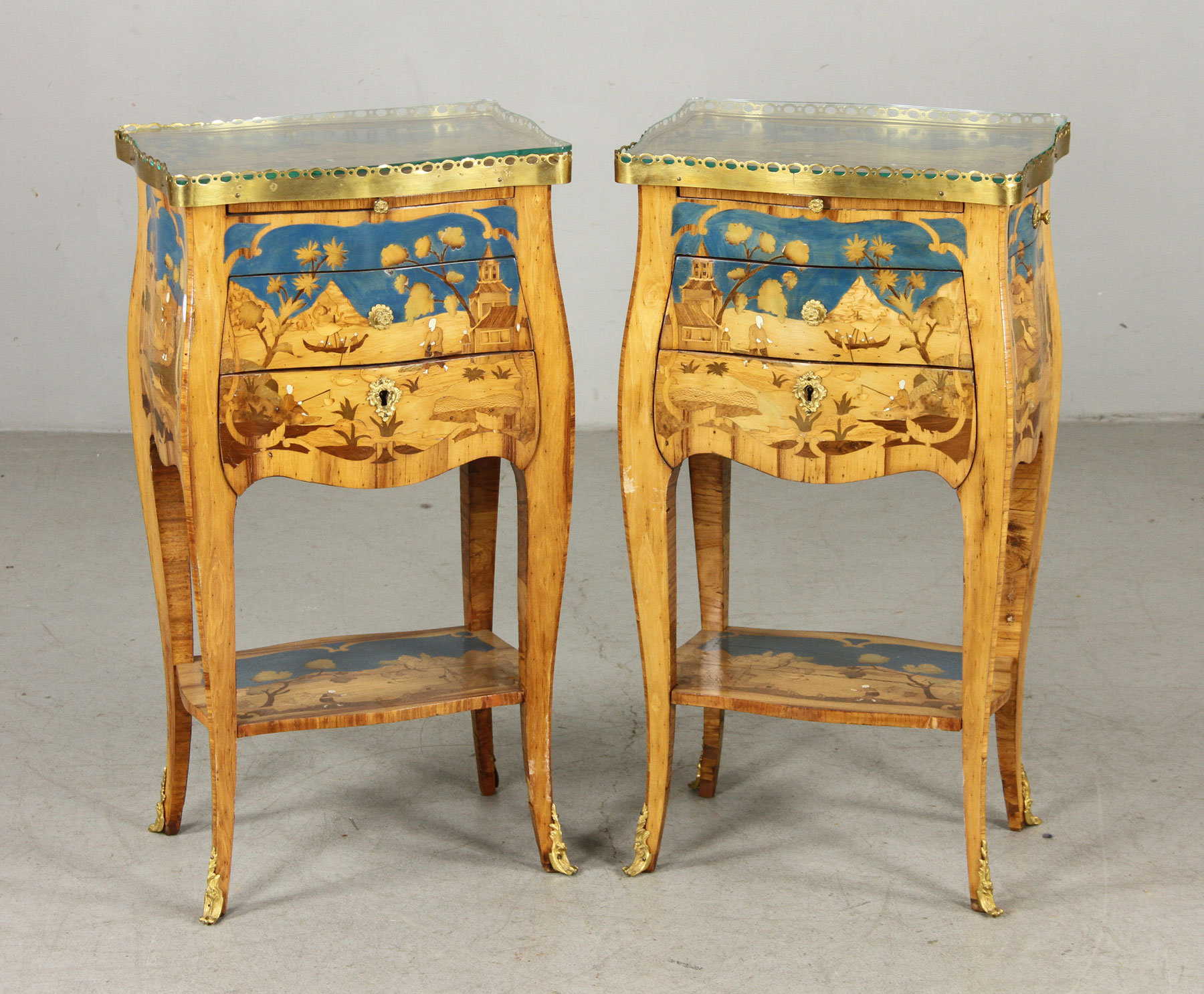 - Pair of unusual French tables, having elaborate marquetry inlaid tops, drawers and shelves
