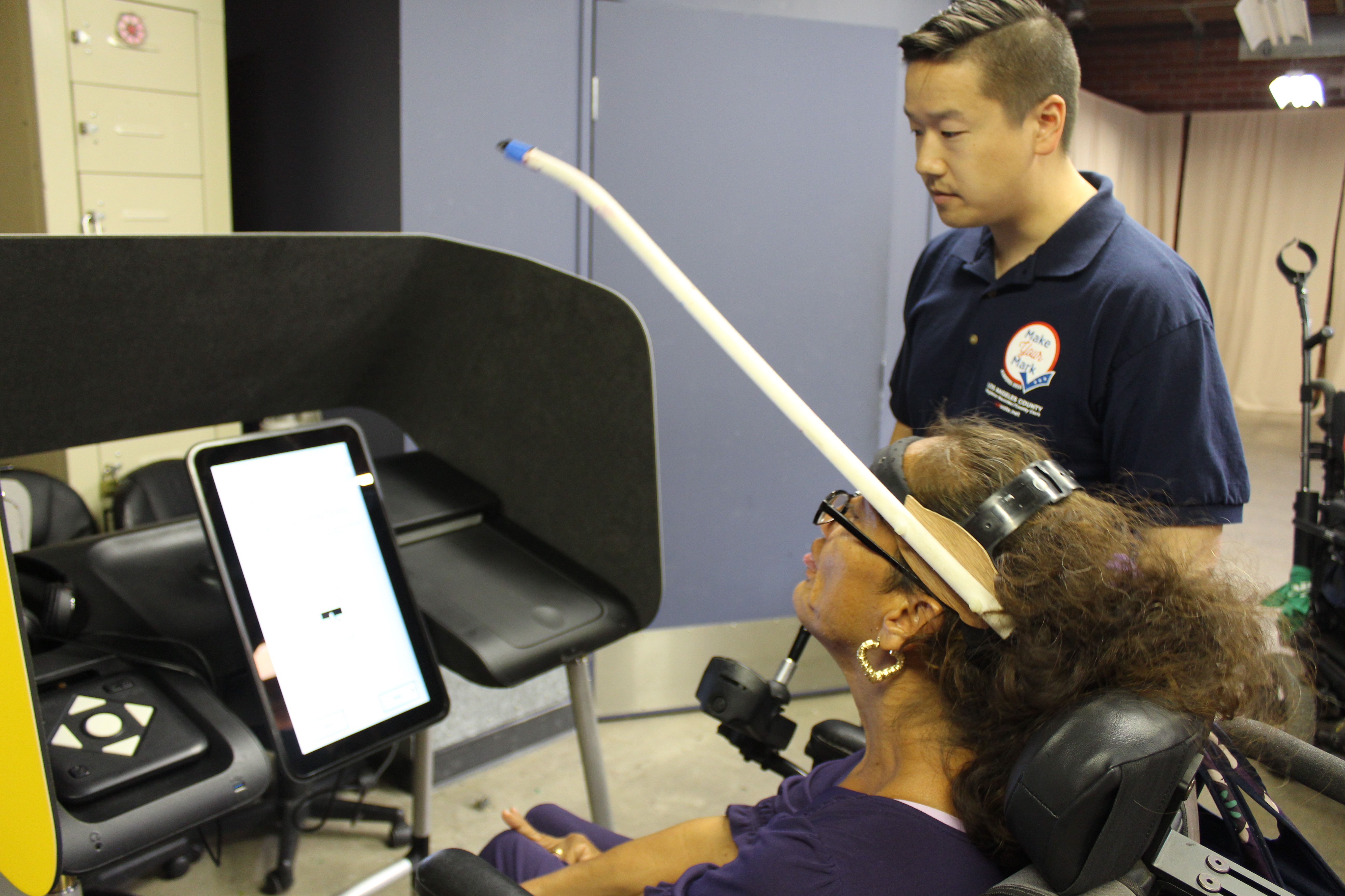 A self-advocate at UCPLA's Washington Place Adult Day Program uses an adaptive device to test an accessible voting prototype.