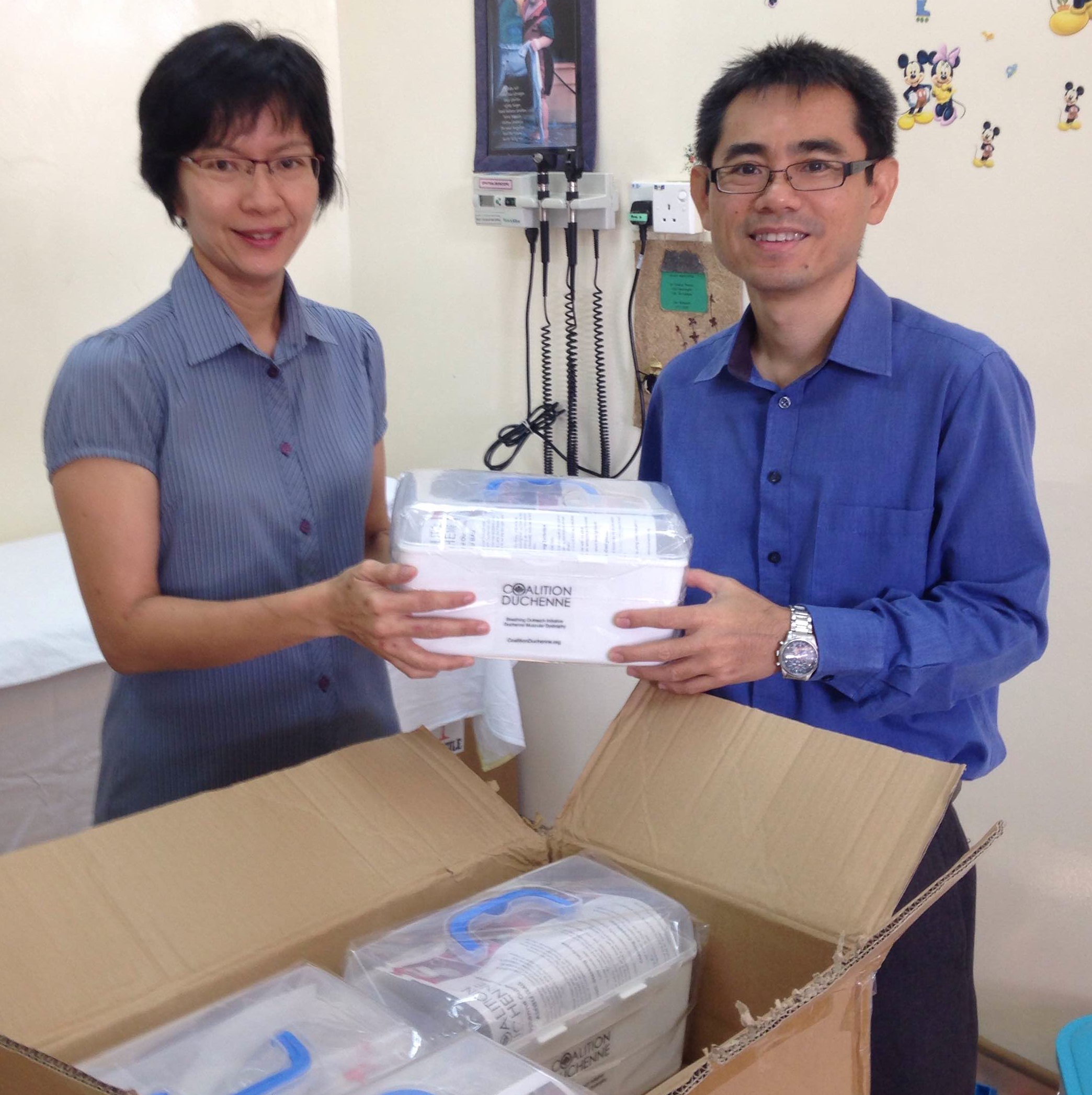 Vivienne Yong, a Malaysian physical therapist, and Dr. Heng Hock Sin unpacking Ambu Bags for the Coalition Duchenne Outreach Initiative in Kota Kinabalu