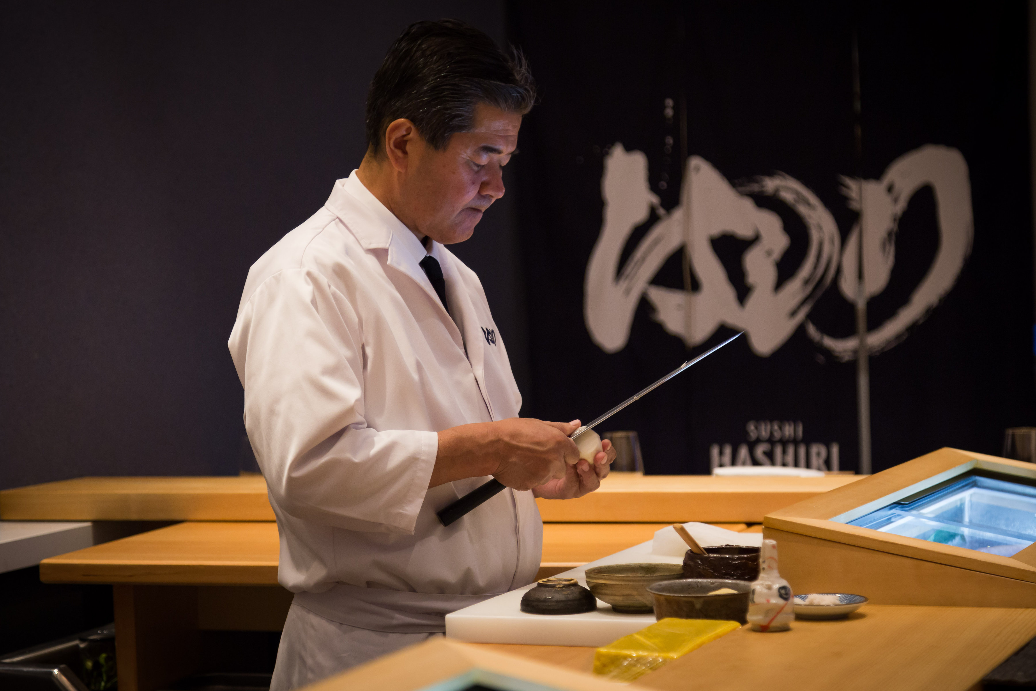 A sushi chef hard at work preparing the day's shipment of fresh fish from the Tsukiji Market