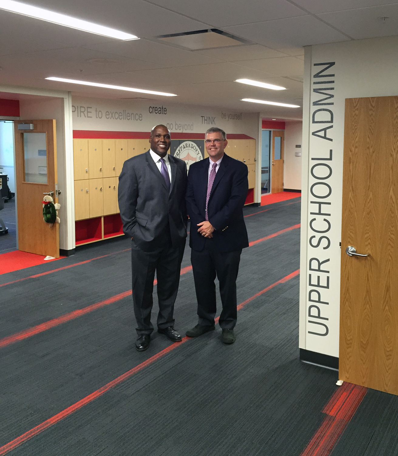 Head of School Kevin M. Plummer and Director of the Upper School Carl C. Carlson celebrate the opening of the renovated Upper School.