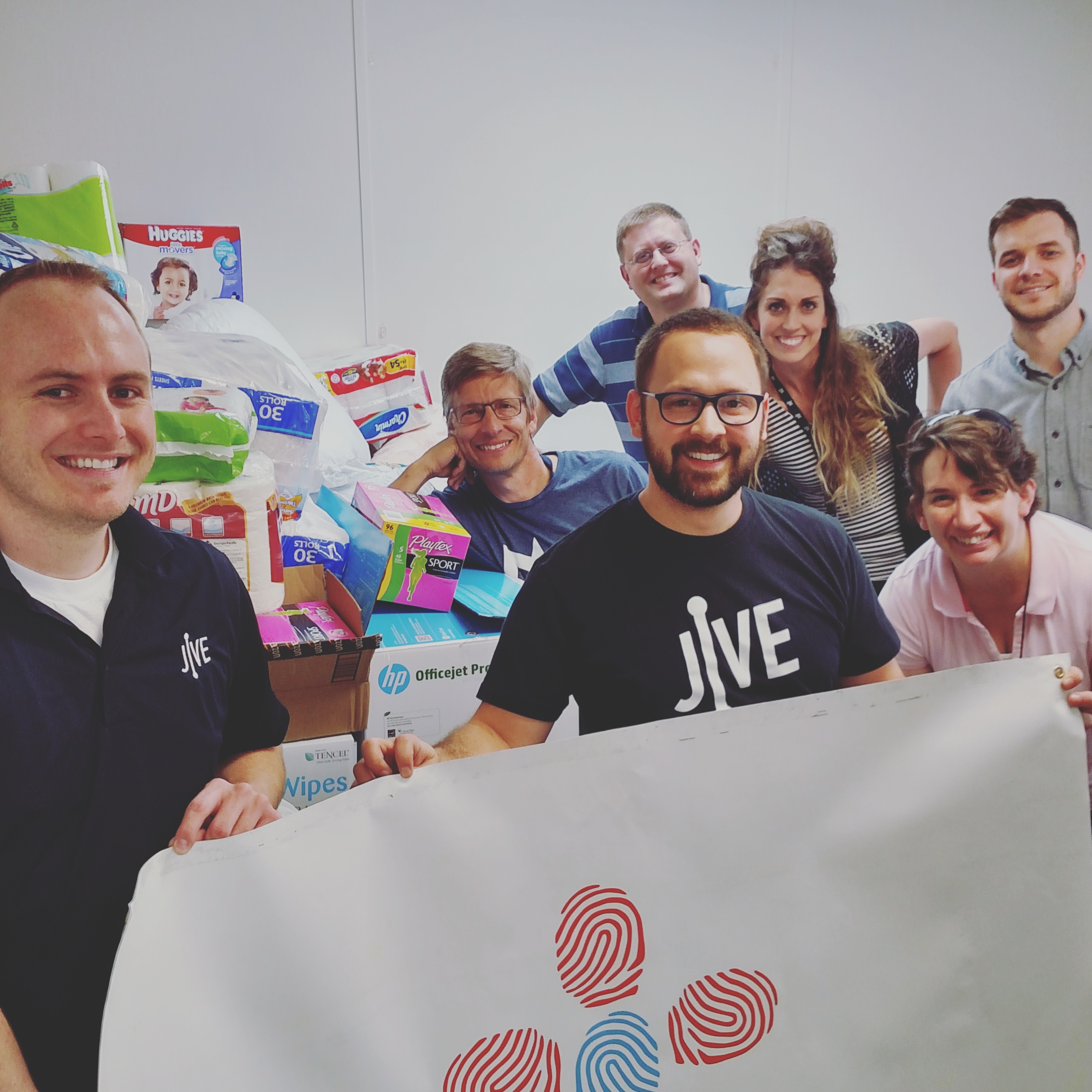 Jive employees deliver donations to Refugee Action Network.