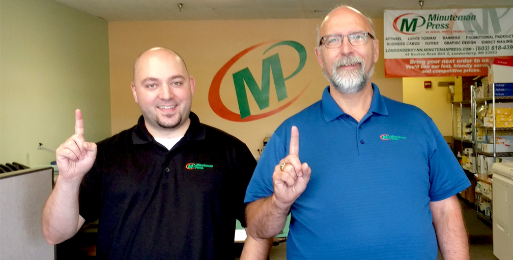 Minuteman Press franchise in Londonderry, NH celebrates 1 year in business. From left to right: Steve Hahn, Graphic Designer/Customer Service Rep.; and Robert Bean, Owner
