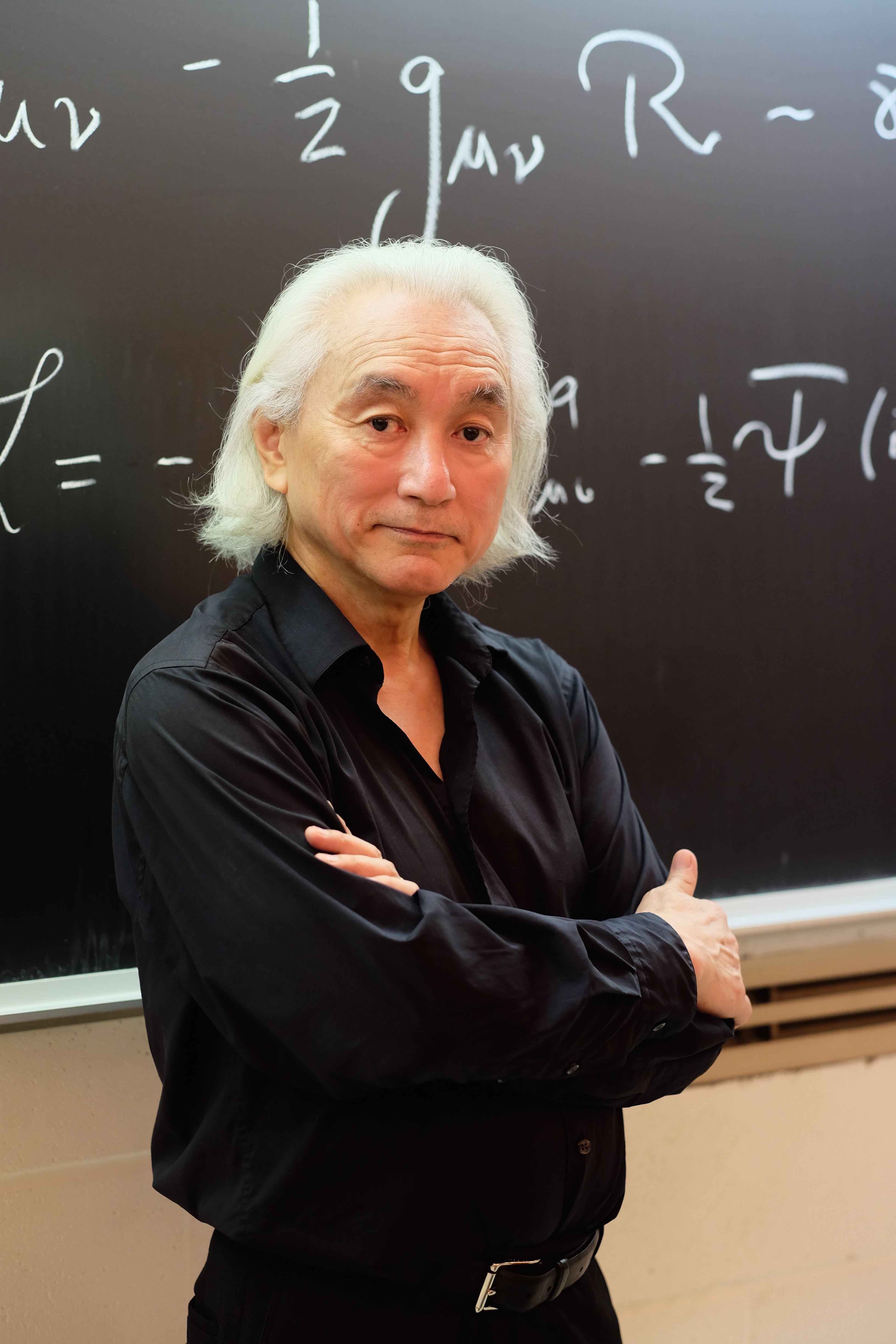 Dr. Kaku poses next to a chalkboard at the City College of New York.
