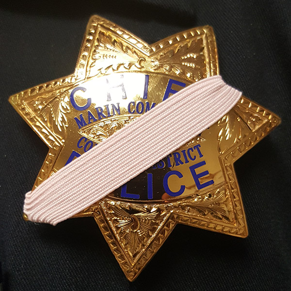College of Marin Police Department will wear pink mourning bands over their badges during October.
