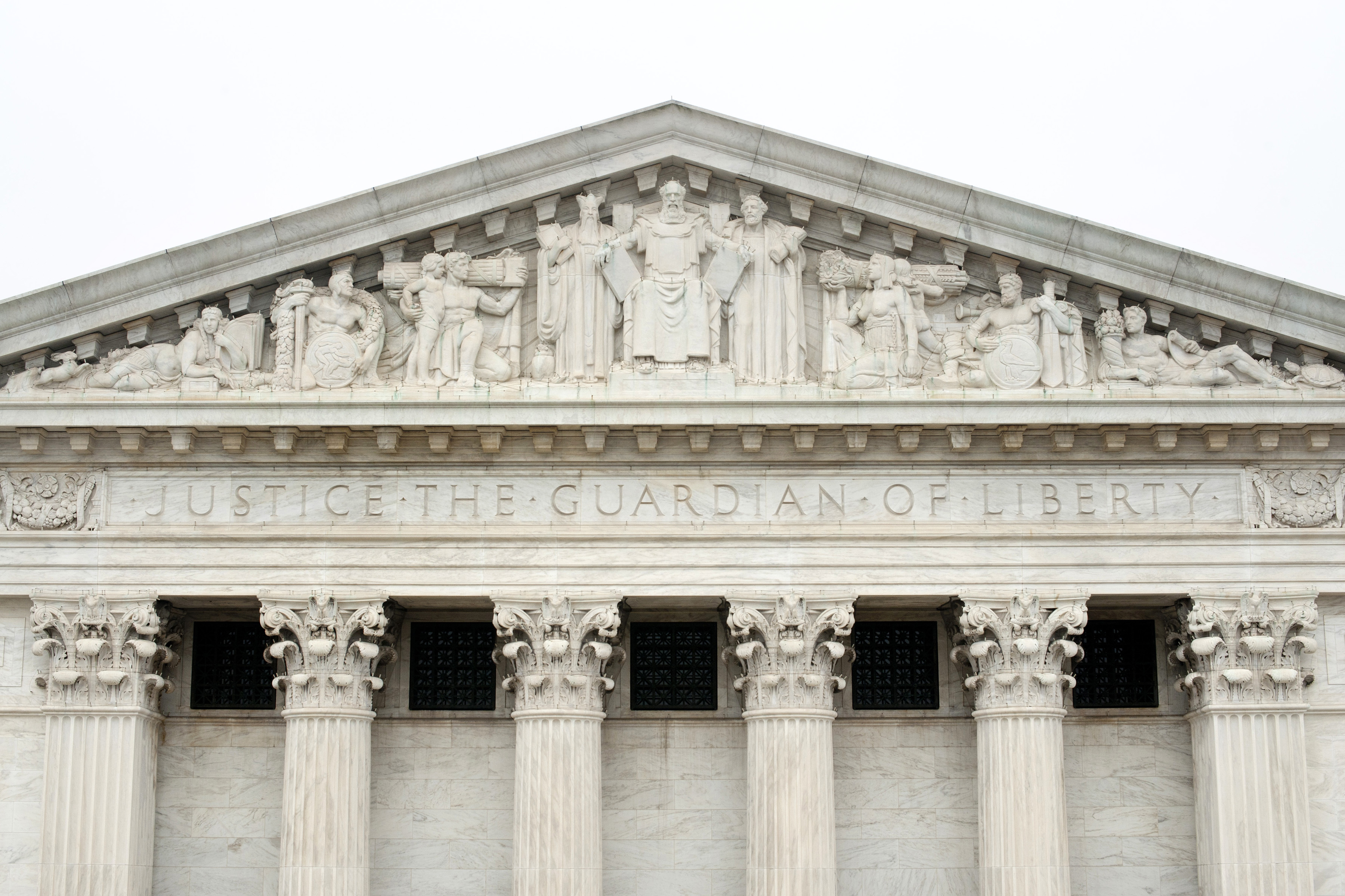 A carving of Moses receiving The Ten Commandments on the facade of the US Supreme Court building in Washington, DC.