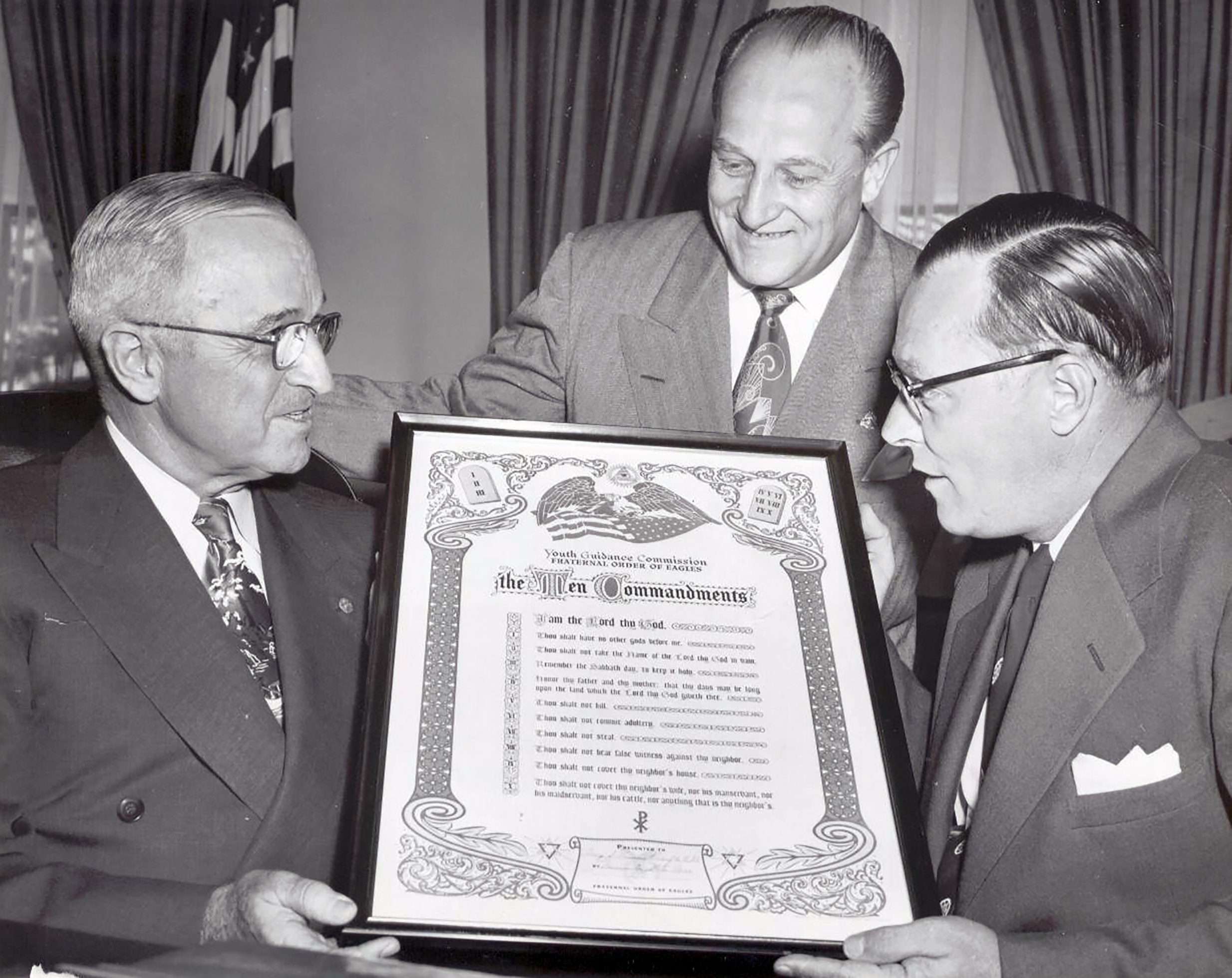 President Harry S. Truman meets with Fraternal Order of Eagles representatives to approve nationwide distribution of The Ten Commandments to combat juvenile delinquency in 1951.