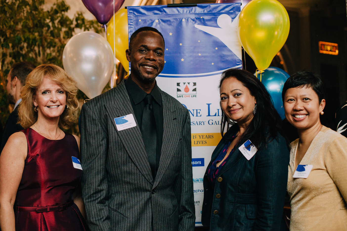 Save One Life founder Laureen Kelley with guest of honor Tony Fernández and two mothers of children with hemophilia--Sunita Bhattarai from Nepal and Myrish Antonio from the Philippines
