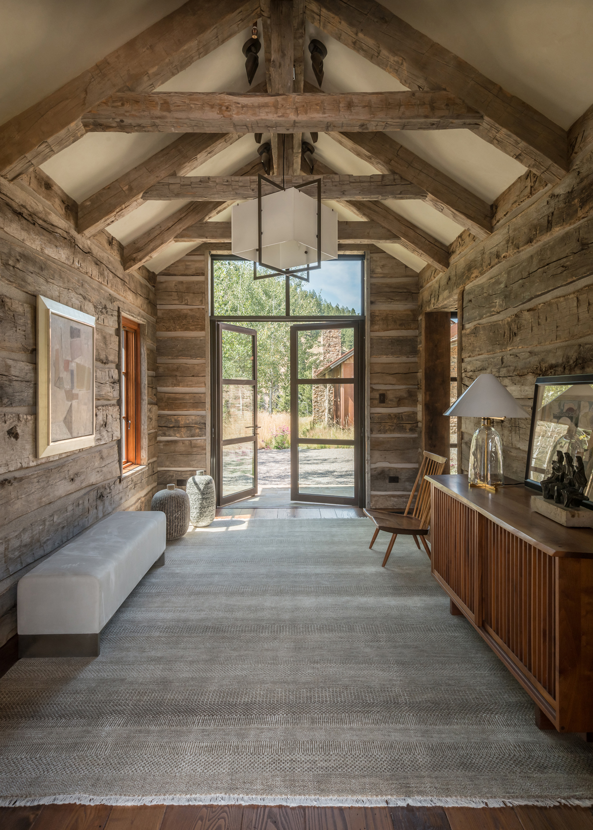 The simplicity of the entryway décor, by WRJ Design, emphasizes the clean lines of the architecture and serves as counterpoint to rustic timber (photo by Audrey Hall).
