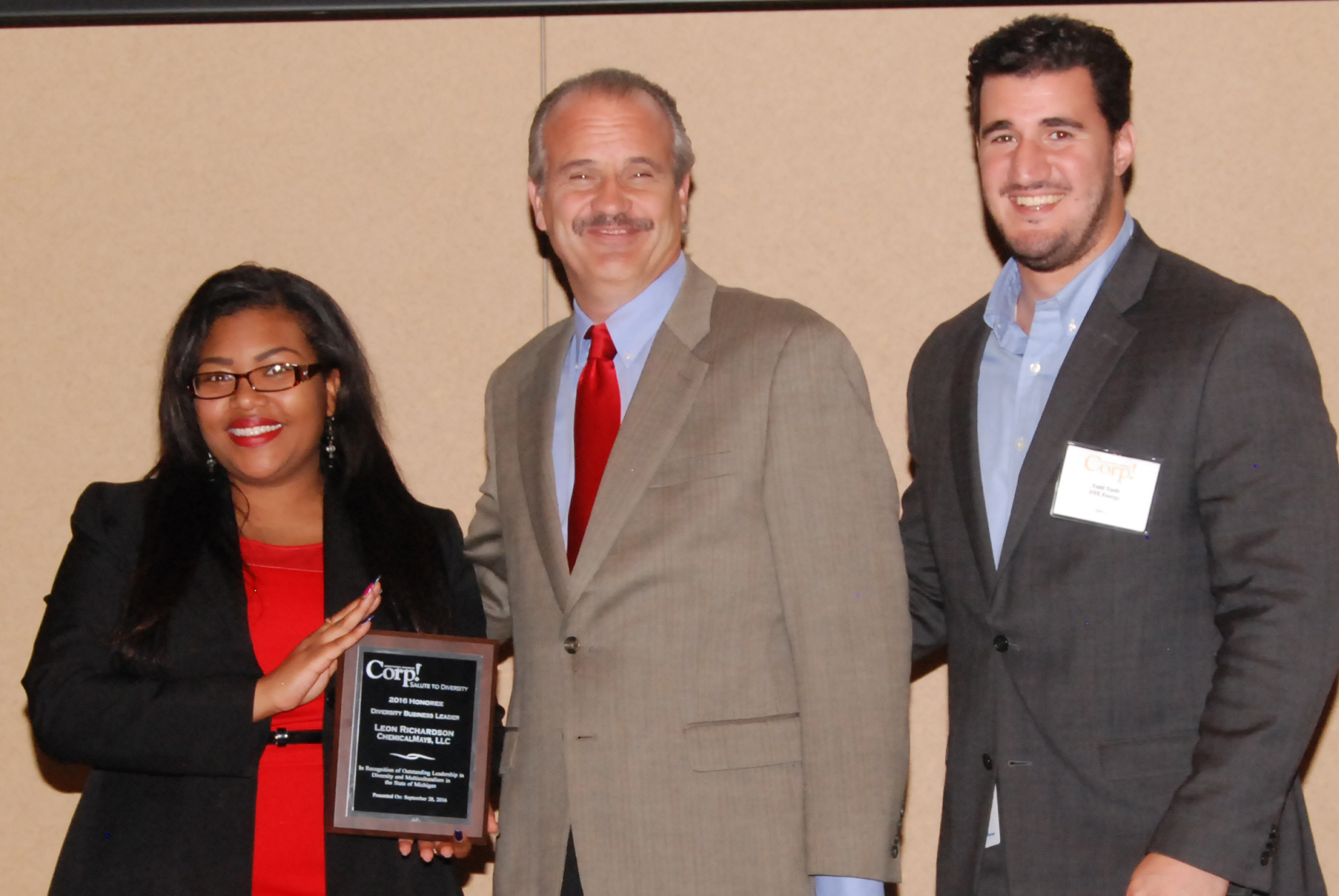 Accepting the Corp! Business Diversity Leadership Award on behalf of Chemico are Tiana Dudley of The Allen Lewis Agency (Left) Paul Duff of The Chemico Group (Center) and Corp! Magazine representative