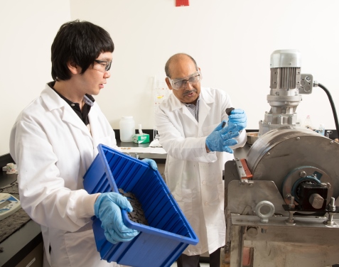 Brajendra Mishra (right), director of WPI’s Center for Resource Recovery and Recycling, and post-doctoral fellow Hyunju Lee use a magnetic separator to remove iron oxide.